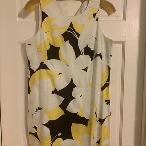 Gently used yellow and black on white background sleeveless dress